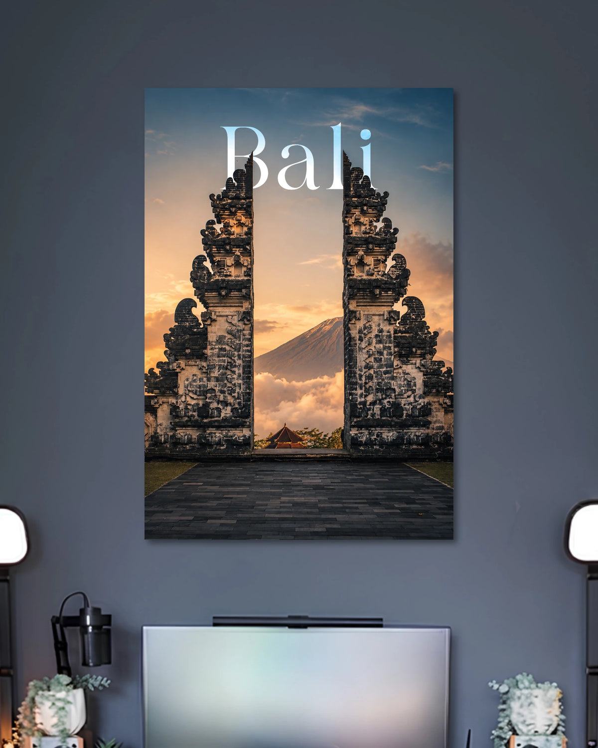 Bali Temple Sunset Travel Poster poster design: Capture Bali's stunning atmosphere with this scenic travel poster. Traditional split temple gates frame a mountain rising above the clouds, illuminated by a warm sunset. Ideal for travel enthusiasts and anyone looking to add an adventurous feel to their space.