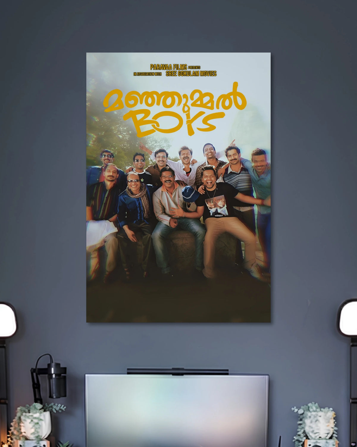 Manjummel Boys Movie Poster poster design: This Manjummel Boys poster brings the film's group of friends together in a cheerful ensemble portrait. The golden Malayalam title stands out against the soft natural background, while the darker lower section adds cinematic depth. A fitting choice for fans of the film.