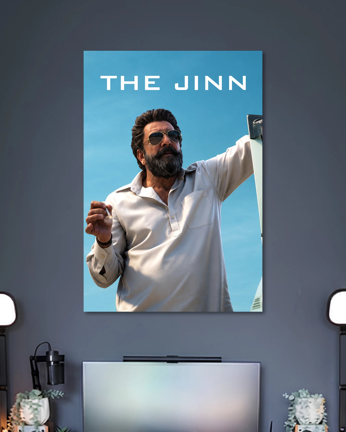 Sanjay Dutt The Jinn Poster poster design: Bring the intense presence of Sanjay Dutt as The Jinn from Dhurandhar to your walls. Set against a clear blue sky, the poster features his bearded look, aviator sunglasses and white outfit for a bold cinematic display.