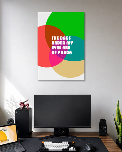 The Bags Under My Eyes Are of Prada Poster poster design: The phrase “The Bags Under My Eyes Are of Prada” takes centre stage in bold white lettering. Overlapping circles in green, red, pink, teal, and beige create a colourful pop art design with a fashion inspired sense of humour.