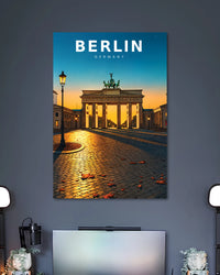 Berlin Brandenburg Gate Poster poster design: Capture the atmosphere of Berlin with this sunset travel poster featuring the iconic Brandenburg Gate. Golden light reflects across the cobblestone plaza while the blue and orange sky frames the historic landmark. A great fit for travel-inspired interiors.