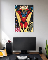 Retro comic illustration of Captain Marvel flying forward in a red-and-blue suit with yellow star emblem beneath CAPTAIN MARVEL text.
