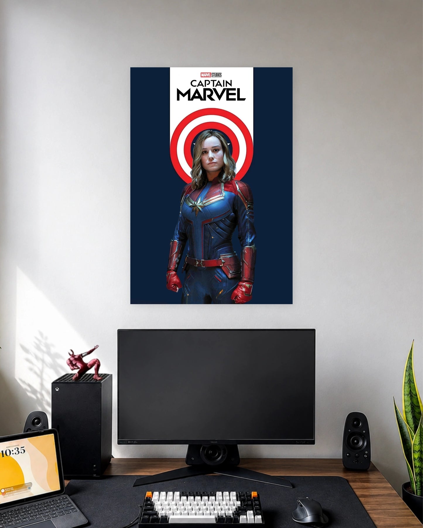 Captain Marvel Shield Emblem Poster wall poster displayed in a modern minimalist workspace setup 1