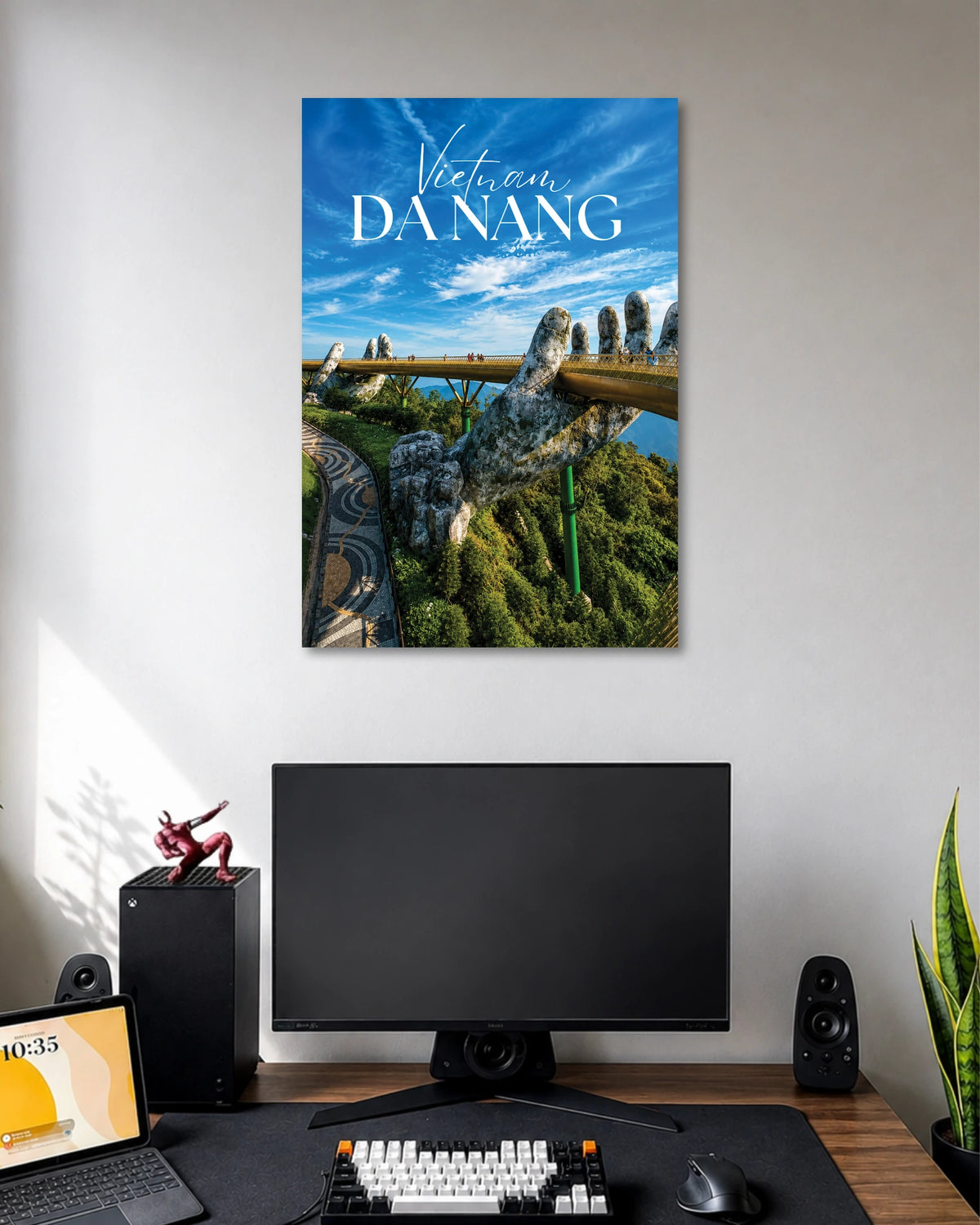 Da Nang Golden Bridge Poster poster design: Bring the iconic Golden Bridge of Da Nang into your space with this Vietnam travel poster. Giant stone hands support the golden walkway above lush green hills beneath a vivid blue sky. A great pick for travel lovers and modern room decor.