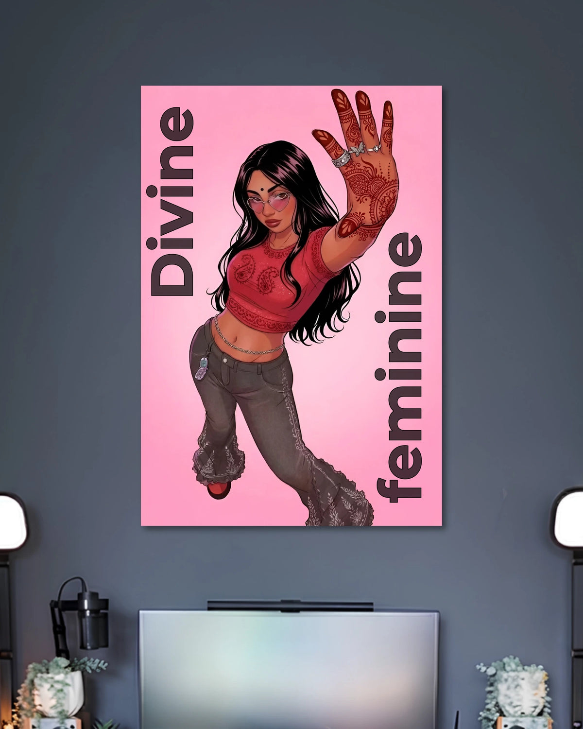 Pink illustrated poster of a long-haired woman raising a henna-patterned palm with vertical DIVINE FEMININE lettering.