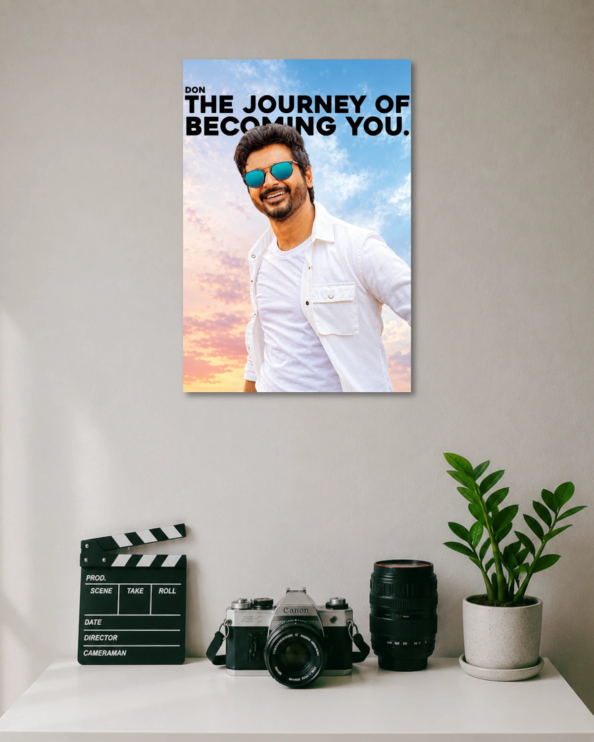 Don The Journey of Becoming You Sivakarthikeyan Poster poster design: Sivakarthikeyan appears in a white outfit and blue sunglasses against a pastel sky, alongside the bold quote “The Journey of Becoming You.” The design combines Tamil cinema style with an uplifting message for your walls.