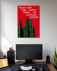 Dress Well Stay Weird Cactus Typography Poster poster design: A vibrant red poster featuring a cluster of green cacti and the playful phrase “Dress Well, Stay Weird, Make Art, Confuse People.” A fun statement piece for creative spaces.