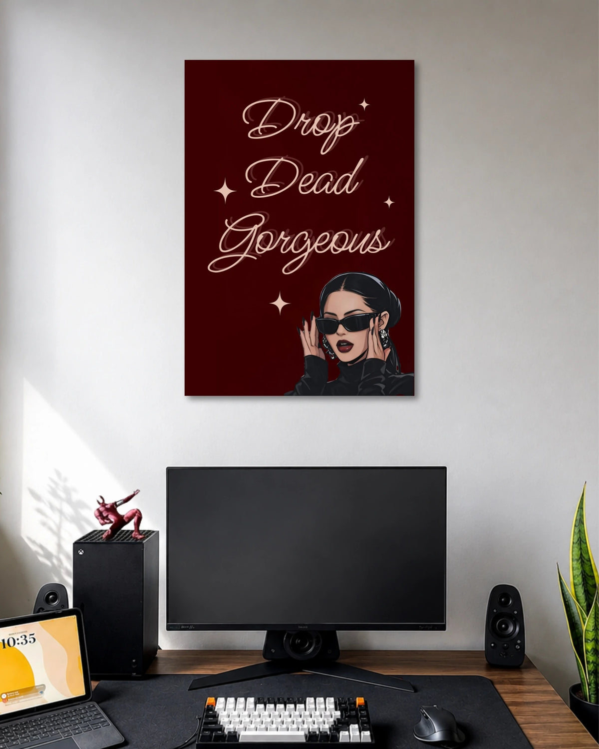 Burgundy poster with the words Drop Dead Gorgeous in elegant white script above a woman wearing black sunglasses.