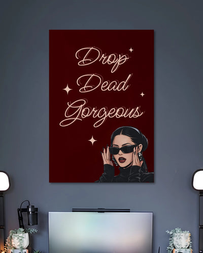 Burgundy poster with the words Drop Dead Gorgeous in elegant white script above a woman wearing black sunglasses.