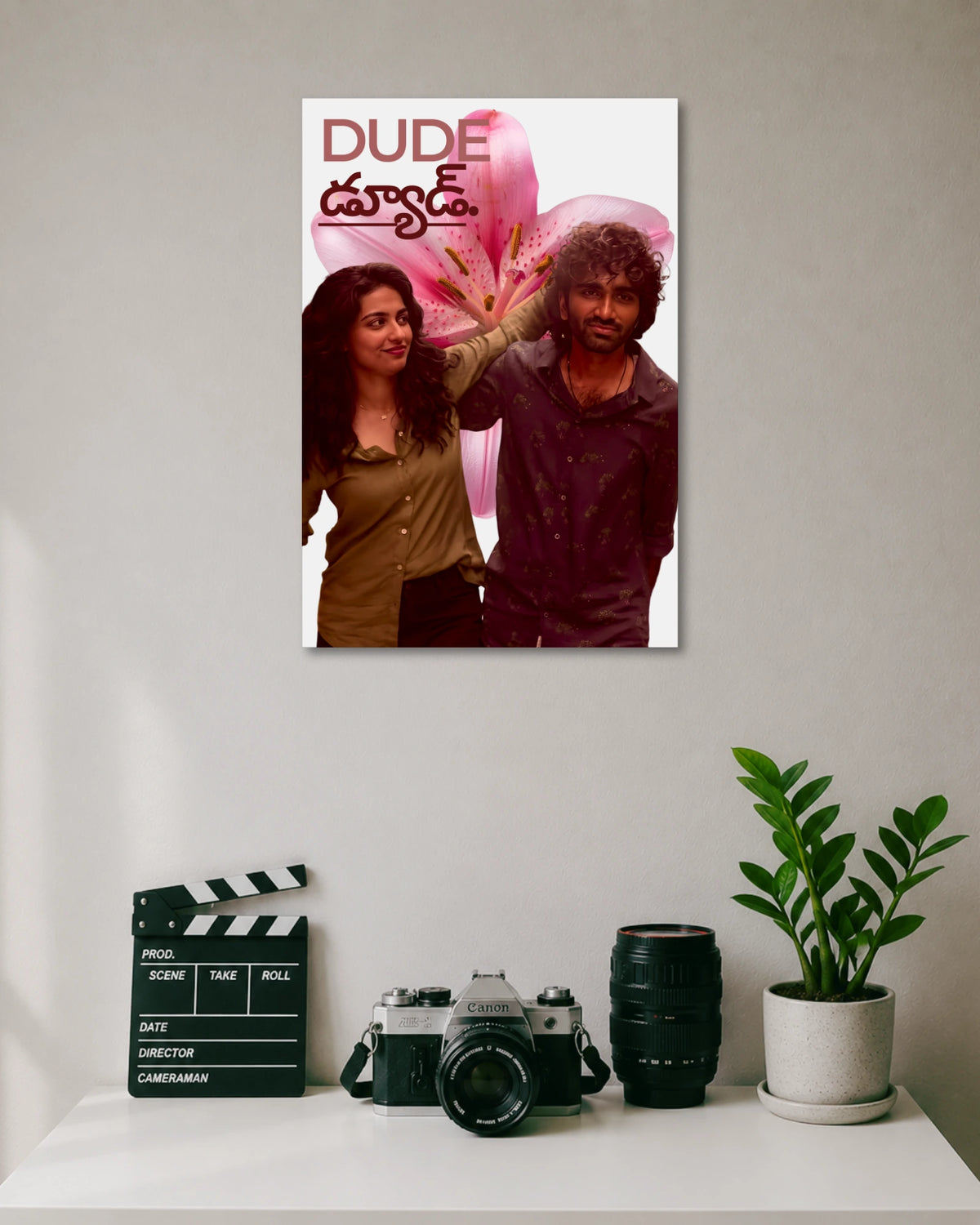 Dude Movie Poster Featuring Pradeep Ranganathan and Mamitha Baiju poster design: Pradeep Ranganathan and Mamitha Baiju appear against a large pink flower, with the Dude title displayed above them. The bold colours and romantic composition bring the film’s youthful energy to your walls.