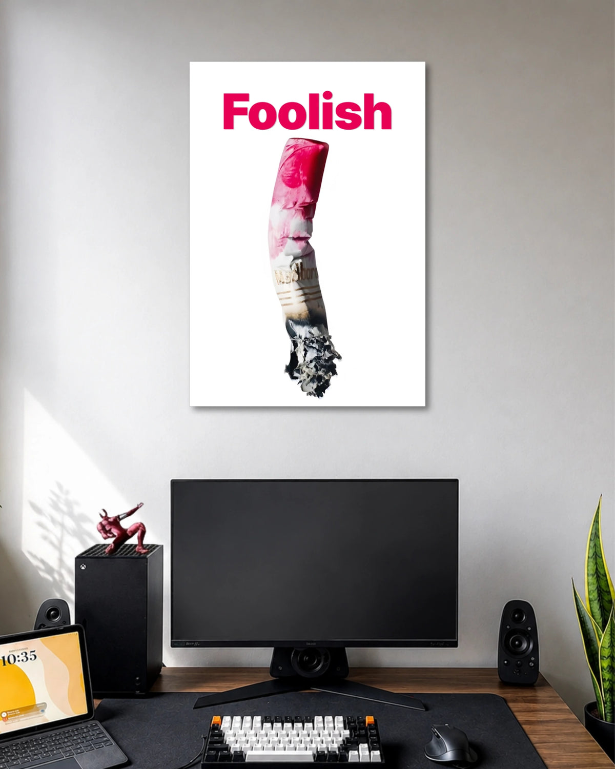Foolish Crushed Cigarette Art Poster poster design: Bold pink typography contrasts with a crushed cigarette in this minimalist composition. The clean white background keeps the focus on the unusual central image. Ideal for contemporary interiors and anyone who appreciates edgy, thought-provoking graphic art.