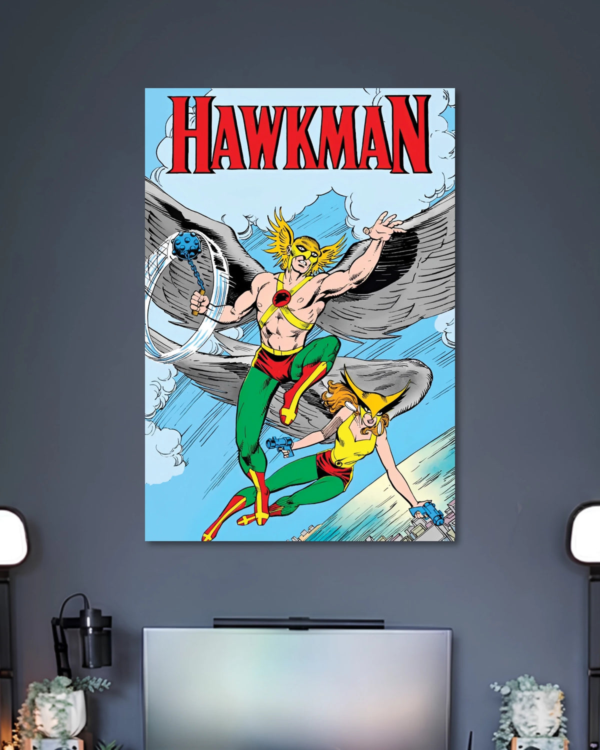 Vintage comic poster showing Hawkman with large gray wings, yellow headgear and a flying figure below against blue skies.