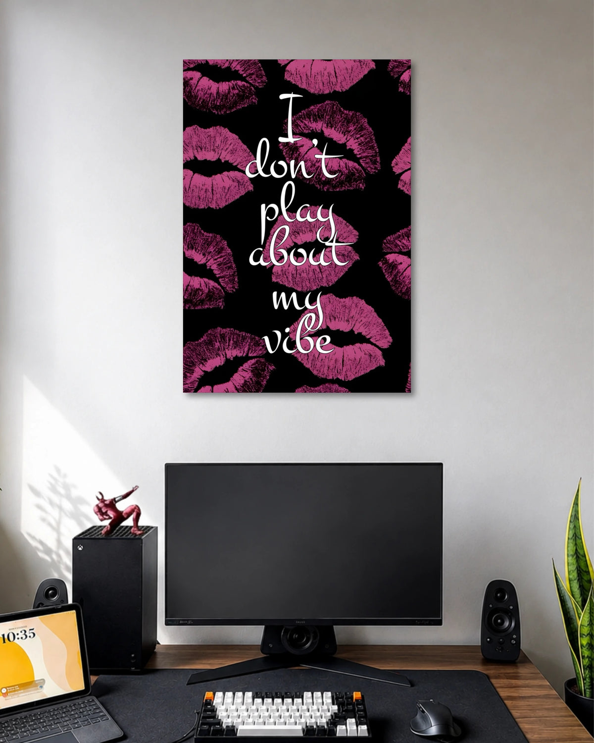 Black poster covered with magenta lipstick kiss marks and the white handwritten quote I don't play about my vibe.