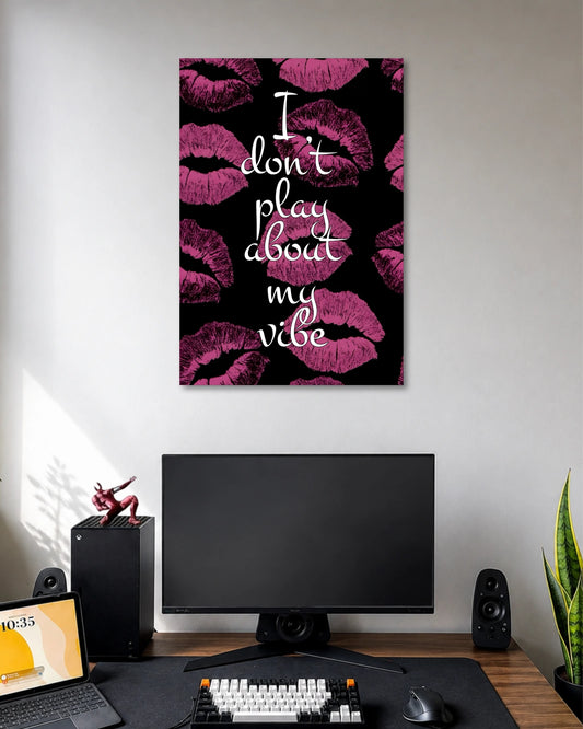 Black poster covered with magenta lipstick kiss marks and the white handwritten quote I don't play about my vibe.