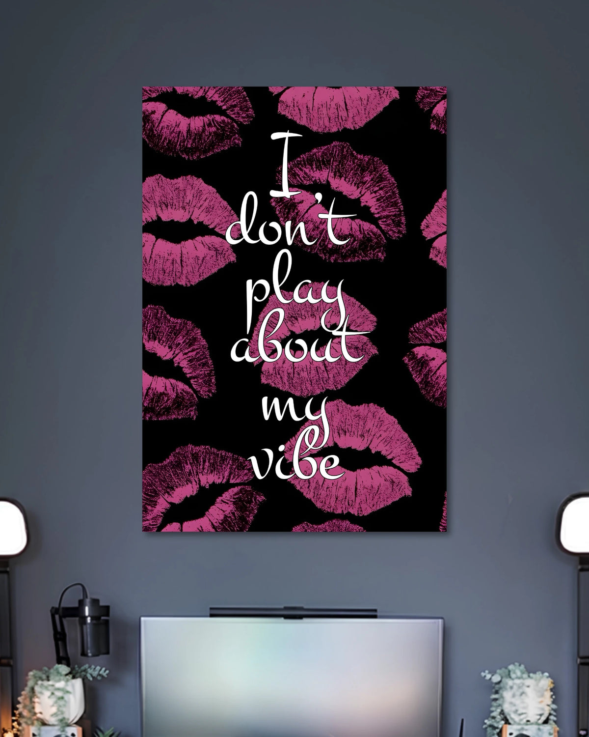 Black poster covered with magenta lipstick kiss marks and the white handwritten quote I don't play about my vibe.