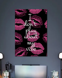 Black poster covered with magenta lipstick kiss marks and the white handwritten quote I don't play about my vibe.