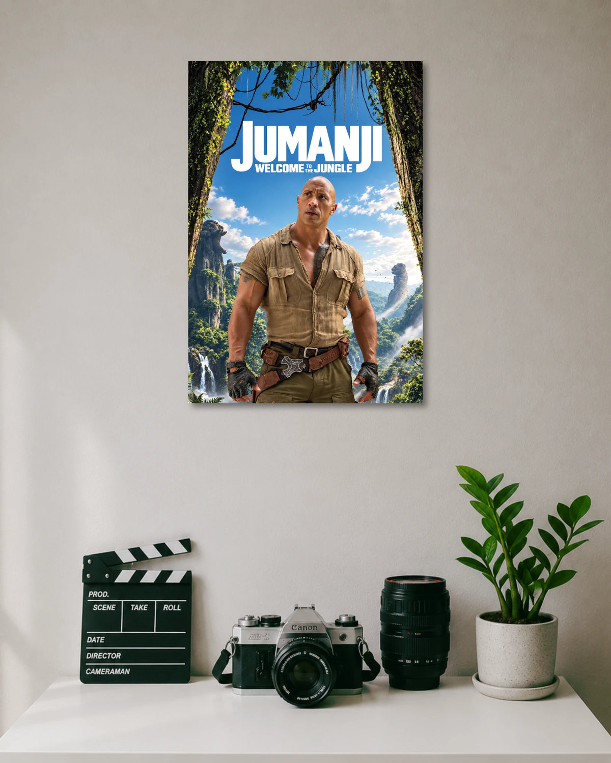 Jumanji Welcome to the Jungle Poster poster design: Bring the adventure of Jumanji to your walls with this poster featuring Dwayne Johnson in a rugged explorer outfit. The lush jungle, waterfalls and bright blue sky create an adventurous look for movie fans and entertainment spaces.