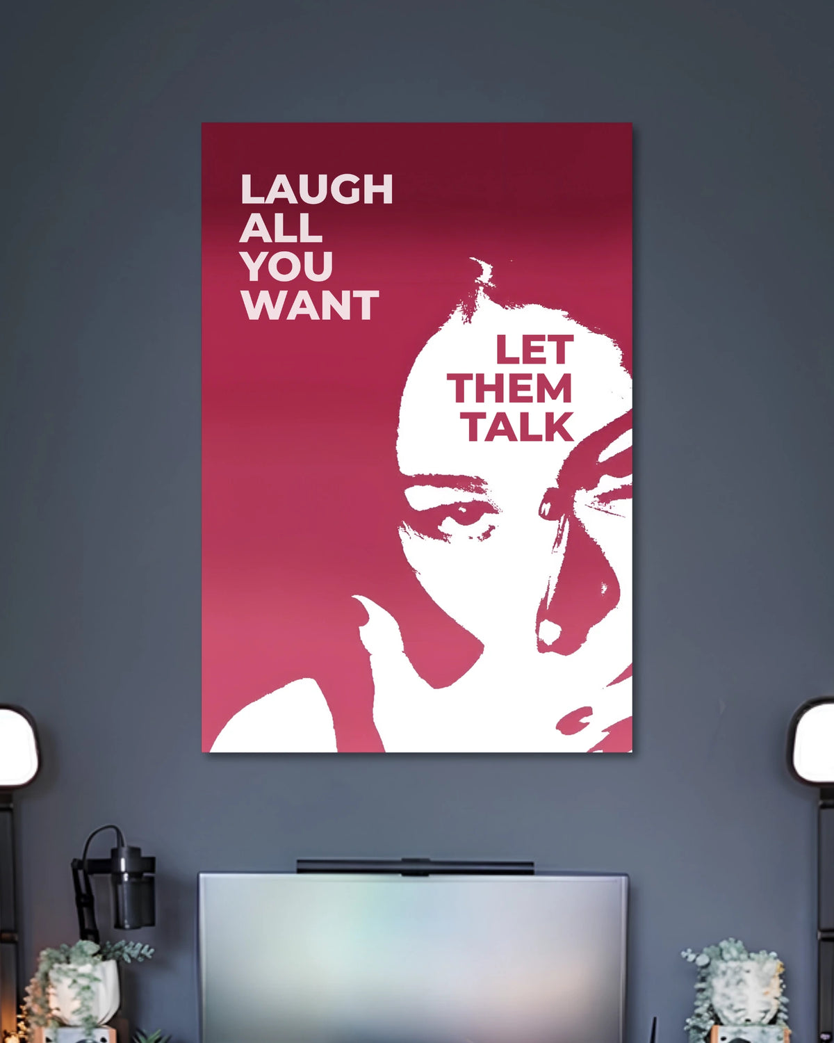 Burgundy graphic poster showing a white stylized woman's face with the words LAUGH ALL YOU WANT and LET THEM TALK.