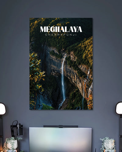 Meghalaya Cherrapunji Waterfall Poster poster design: This Meghalaya poster captures a slender waterfall descending between towering rocky cliffs and lush forest. Deep green foliage, rugged textures and the flowing white water create a dramatic natural landscape. The clean Cherrapunji typography completes this scenic design for travel and nature enthusiasts.