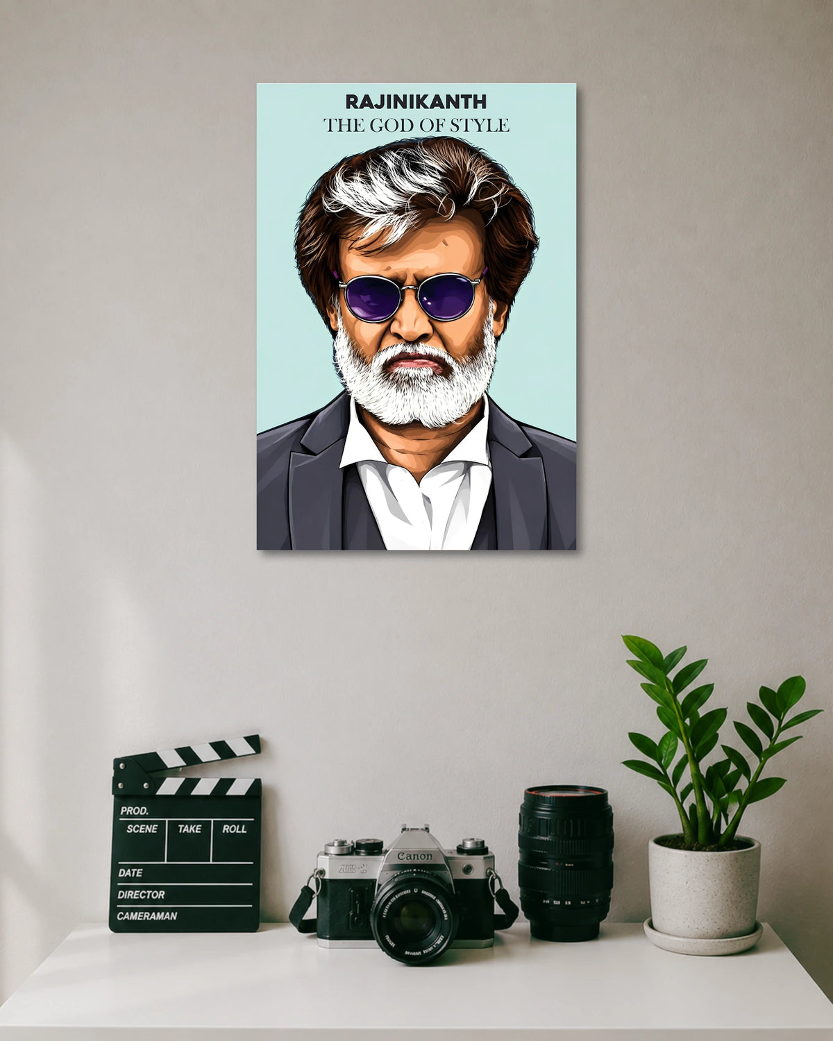 Rajinikanth The God of Style Kabali Poster poster design: An illustrated portrait of Rajinikanth featuring his signature white hair and beard, purple sunglasses and sharp suit against a clean pastel background. Titled "The God of Style," this poster celebrates the superstar's legendary look and unmistakable charisma in movie Kabali.