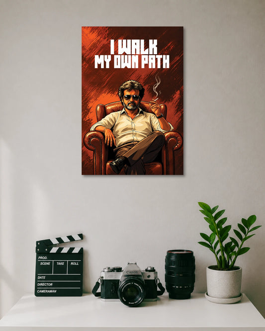 Rajinikanth I Walk My Own Path Poster poster design: Rajinikanth sits confidently in a leather armchair, wearing sunglasses and holding a cigarette against a fiery red background. Bold white typography reads “I Walk My Own Path,” capturing his iconic screen presence in a striking cinematic art style.
