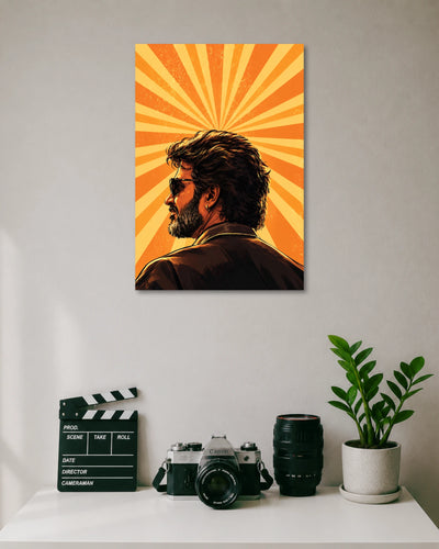 Rajinikanth Orange Sunburst Poster poster design: Rajinikanth appears in side profile wearing sunglasses, a dark jacket and an earring. Radiating orange and yellow sunbeams fill the background, creating a retro inspired composition centred on the iconic Superstar's distinctive look.