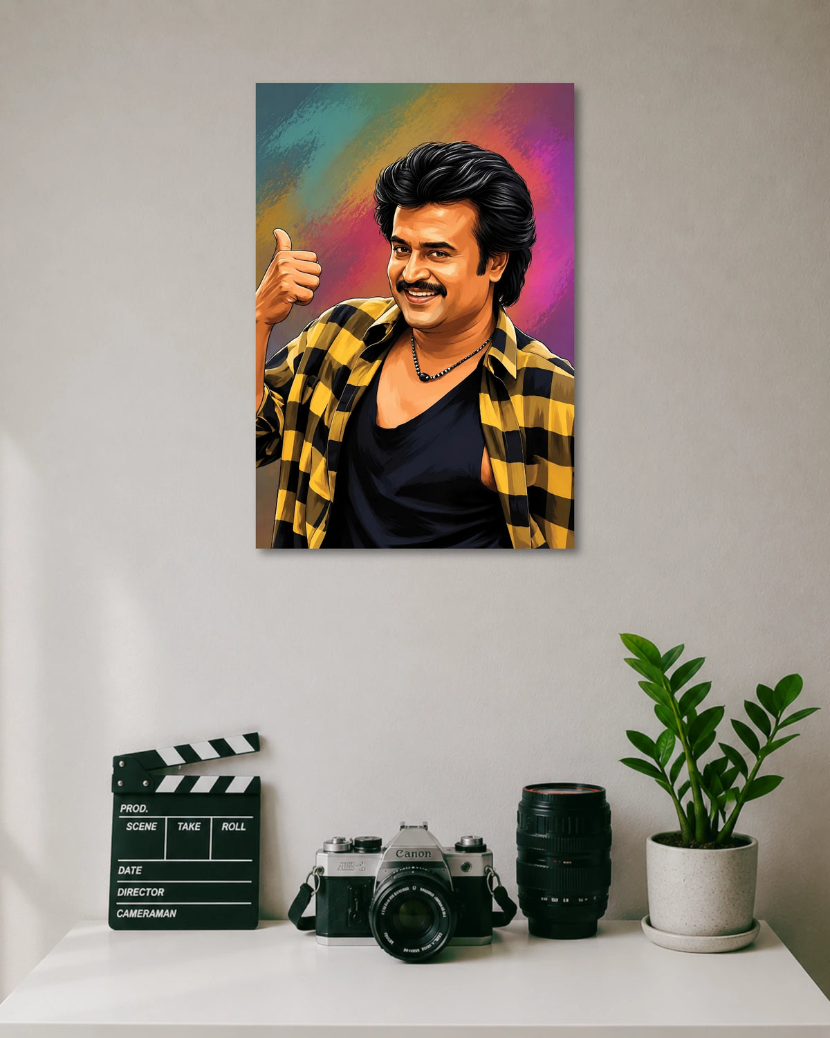 Rajinikanth Thumbs Up Pop Culture Poster poster design: Rajinikanth smiles and gives a thumbs-up in this vibrant illustrated portrait. His signature hairstyle and moustache stand out against a textured multicolour background, while the yellow and black checked shirt adds contrast to this tribute to Tamil cinema.