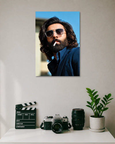 Ranbir Kapoor Animal Movie Poster poster design: Make a bold statement with this Ranbir Kapoor poster inspired by his Animal movie look. The long hair, thick beard, sunglasses and navy blue outfit create a striking portrait. Perfect for fans of the film and contemporary Indian cinema.