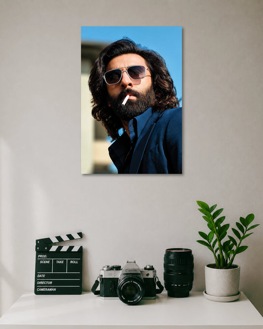 Ranbir Kapoor Animal Movie Poster poster design: Make a bold statement with this Ranbir Kapoor poster inspired by his Animal movie look. The long hair, thick beard, sunglasses and navy blue outfit create a striking portrait. Perfect for fans of the film and contemporary Indian cinema.