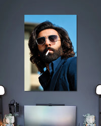 Ranbir Kapoor Animal Movie Poster poster design: Make a bold statement with this Ranbir Kapoor poster inspired by his Animal movie look. The long hair, thick beard, sunglasses and navy blue outfit create a striking portrait. Perfect for fans of the film and contemporary Indian cinema.