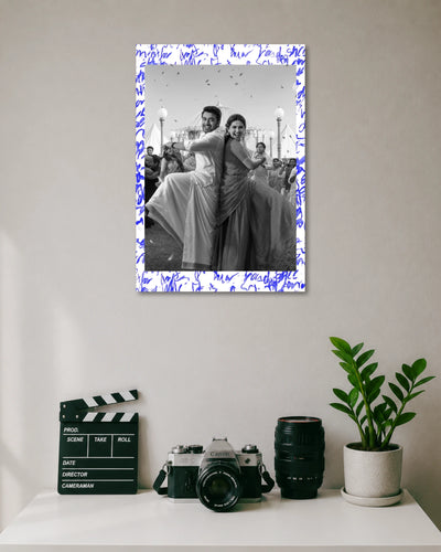 Suriya Mamitha Baiju Vishwanath Sons Poster poster design: Celebrate the pairing of Suriya and Mamitha Baiju with this Vishwanath & Sons poster. The black and white design captures the couple dancing in traditional outfits, with blue handwritten details adding a distinctive finish.