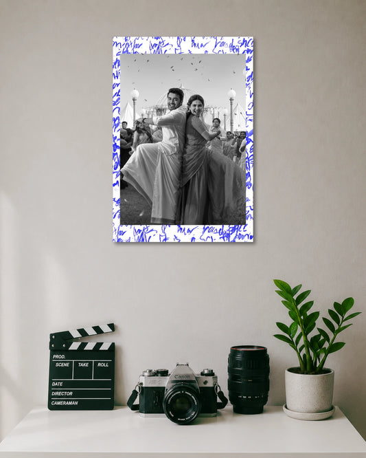 Suriya Mamitha Baiju Vishwanath Sons Poster poster design: Celebrate the pairing of Suriya and Mamitha Baiju with this Vishwanath & Sons poster. The black and white design captures the couple dancing in traditional outfits, with blue handwritten details adding a distinctive finish.
