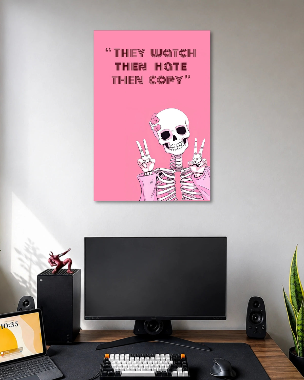 Hot-pink poster with a smiling white skeleton raising both hands in peace signs under THEY WATCH THEN HATE THEN COPY text.