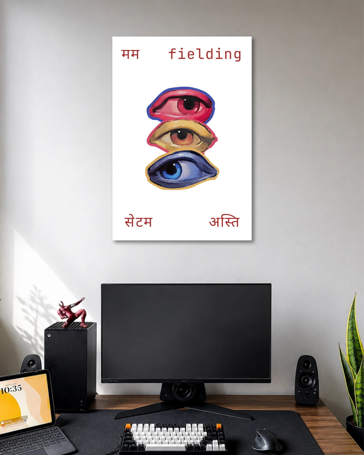 Three Eyes Fielding Typography Art Poster poster design: Three illustrated eyes in red, yellow, and blue are stacked vertically against a clean white background. Hindi lettering and the English word “fielding” frame the artwork, creating an unusual graphic design with a playful, contemporary feel.