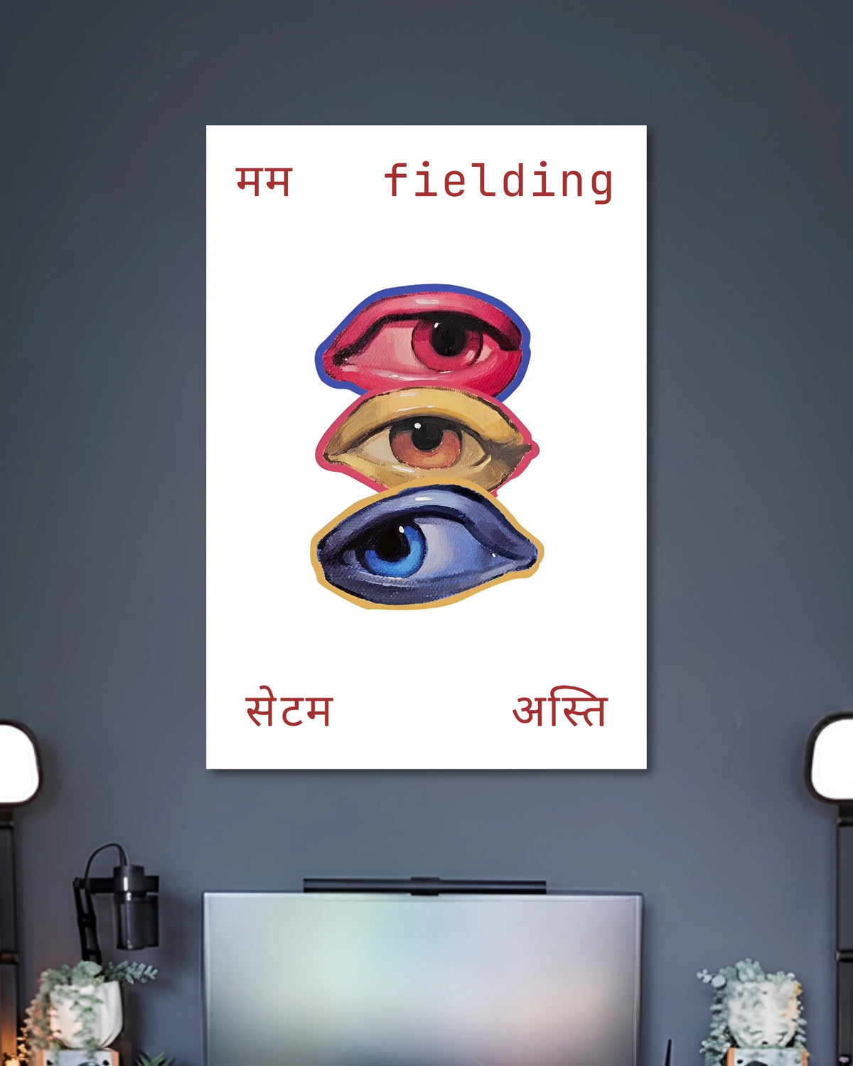 Three Eyes Fielding Typography Art Poster poster design: Three illustrated eyes in red, yellow, and blue are stacked vertically against a clean white background. Hindi lettering and the English word “fielding” frame the artwork, creating an unusual graphic design with a playful, contemporary feel.
