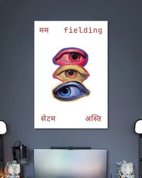 Three Eyes Fielding Typography Art Poster poster design: Three illustrated eyes in red, yellow, and blue are stacked vertically against a clean white background. Hindi lettering and the English word “fielding” frame the artwork, creating an unusual graphic design with a playful, contemporary feel.