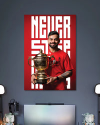 Virat Kohli RCB Trophy Poster poster design: Celebrate Virat Kohli with this RCB poster featuring him holding the IPL trophy in his red jersey. The striking red background and “Never Stop” typography make it a standout addition to a cricket fan's room.